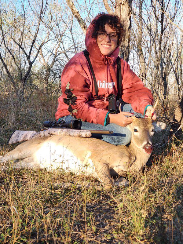Student Hunter posing with her deer