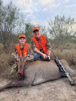 Hunters posing with harvest