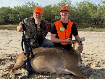Hunter and guide pose with harvest