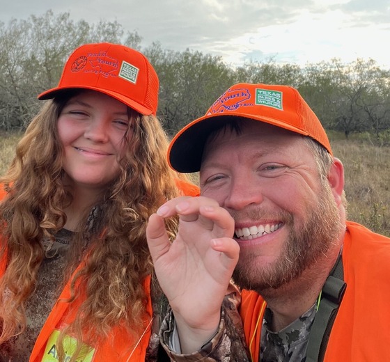 Student and mentor pose in a selfie outdoors