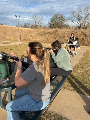 Ladies shoot rifles at a rfile range
