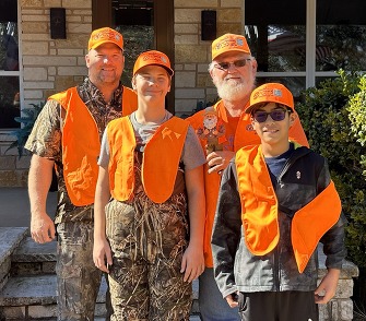 Bowhunter instructors pose with their students in orange vests