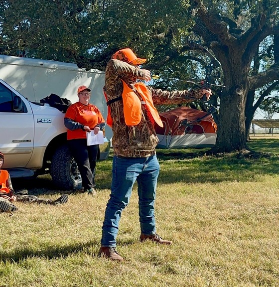 Hunter Ed instructor watches as archer shoots their bow