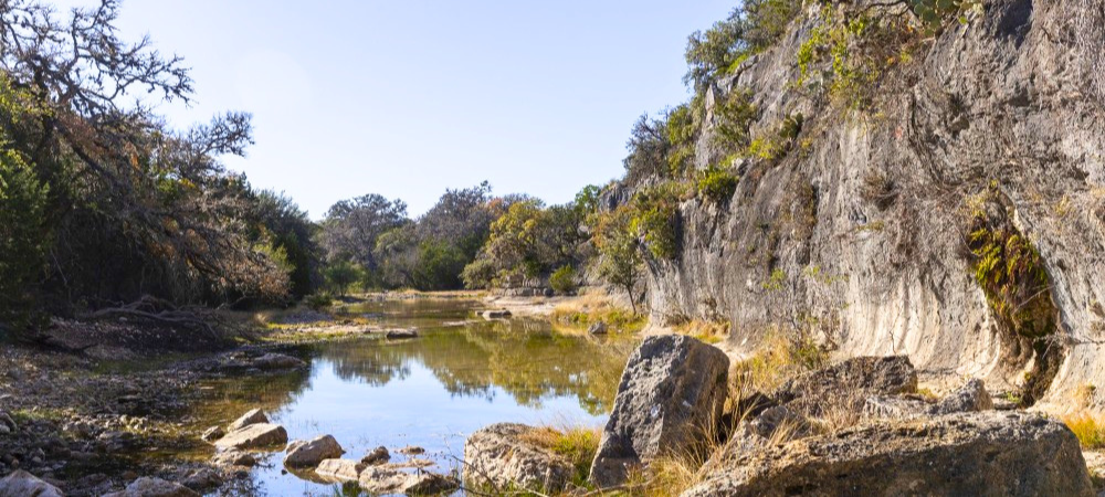 Cliffside next to creek and trees at Silver Lake SP 
