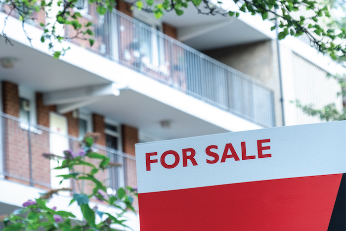 For sale sign in front of a building