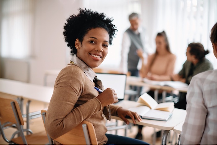 Woman at desk smiling at camera