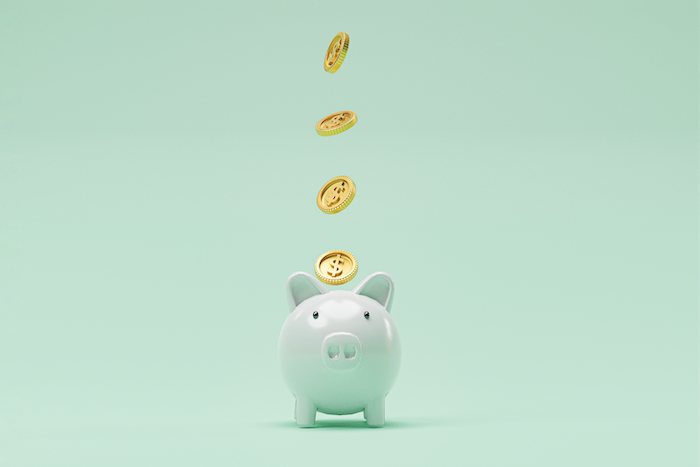 Piggy bank on green background