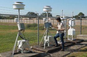 Technician working on air monitoring tower