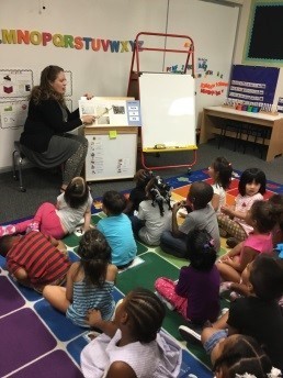 Children and teacher participating in interactive reading