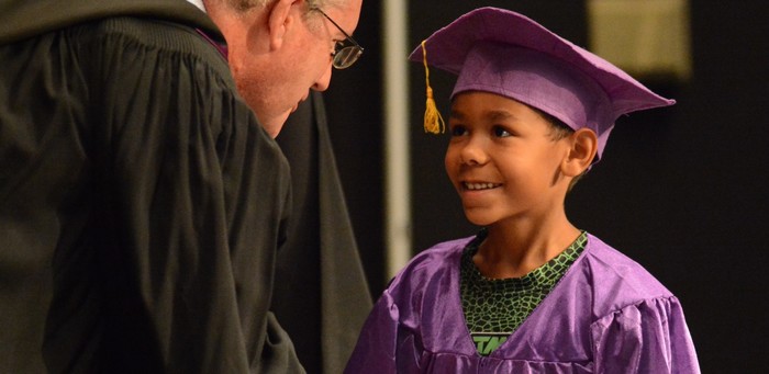 Young Child in Cap and Gown at K Graduation