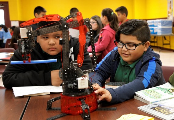 Male students working on a scientific model
