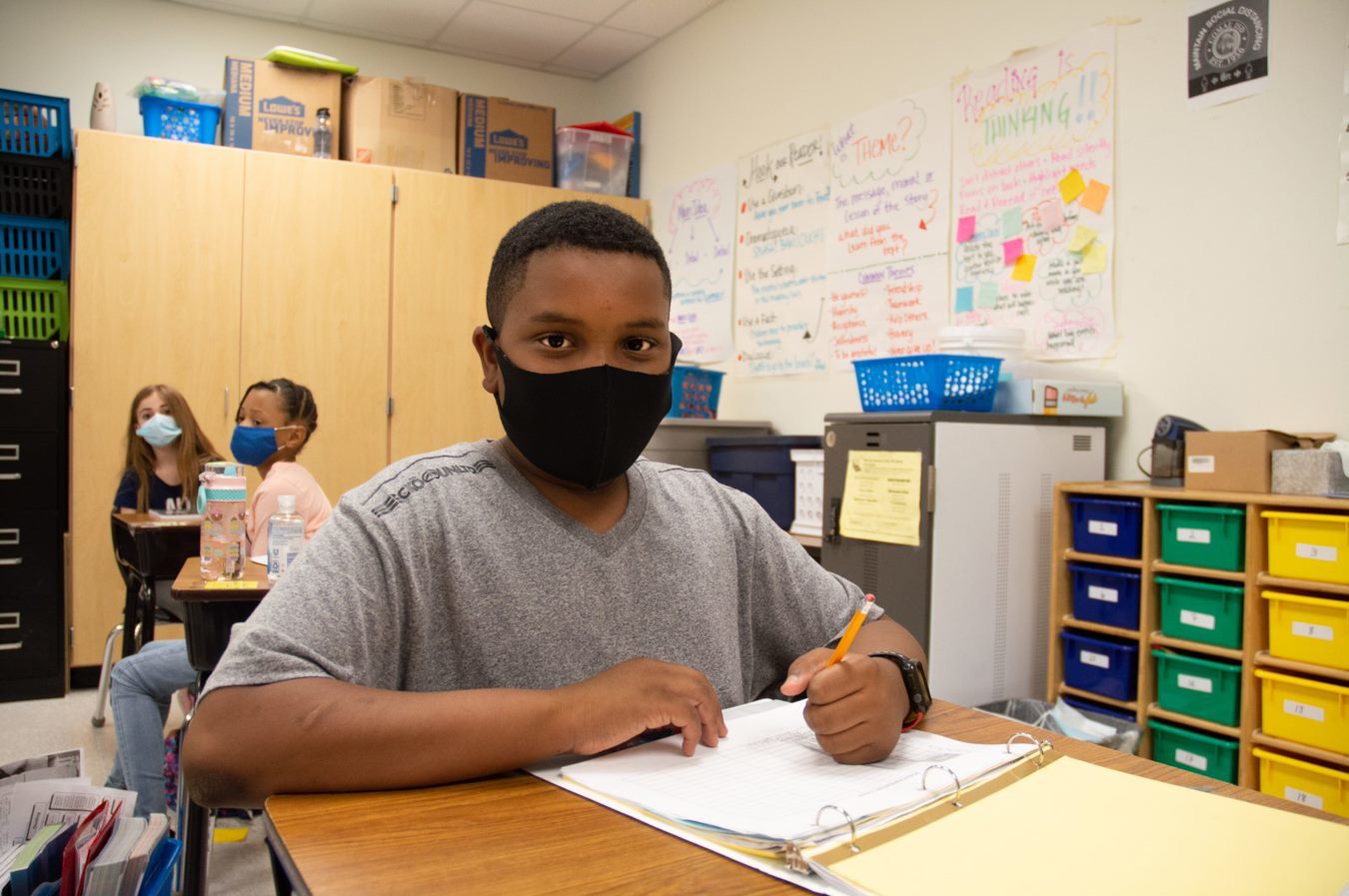 boy with mask in classroom 
