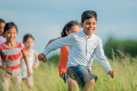 Children running in summer field