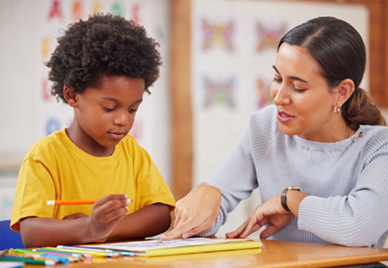 Teacher helping a student at a desk