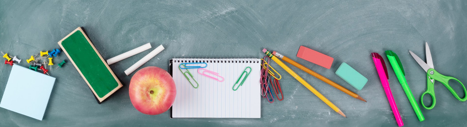 school supplies on chalkboard surface