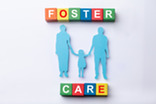 foster care: silhouette of two parents holding child's hand