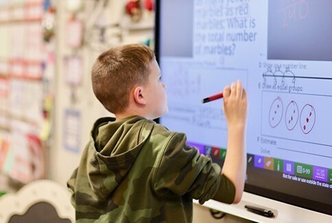 boy at whiteboard with pen
