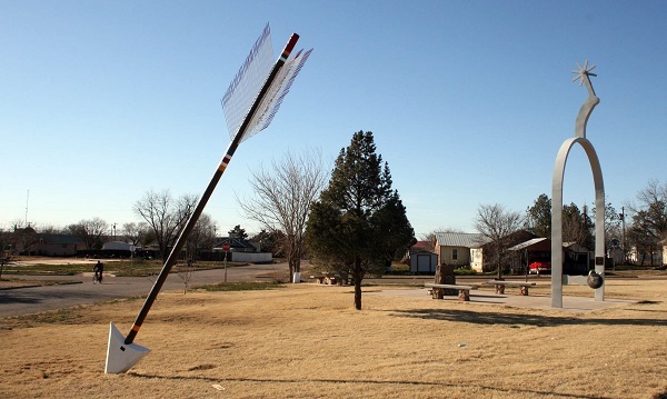 Giant arrow sculpture piercing the dry ground