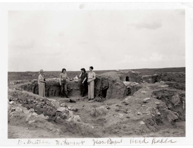 Four female archaeologists stand in a pit at an excavation site in 1941. 