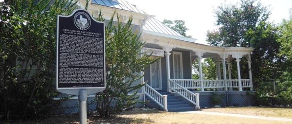 Texas historical marker in front of a Victorian-style home