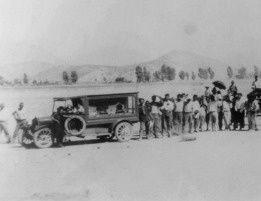 A funeral procession follows a hearse, circa 1910. 