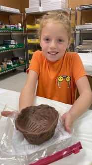 A little girl and her pinch pot.