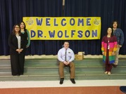 Dr. Wolfson in front of a sign saying "Welcome Dr. Wolfson" with educators