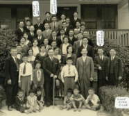 Image of Japanese farmers and family smiling and wearing nice clothes. The image is in black and white.