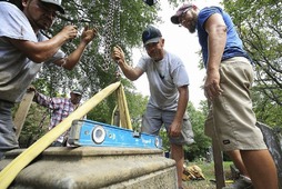 Photograph of a leveling tool on a historic headstone during a restoration workshop
