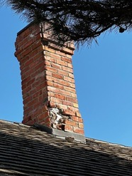 Image of a brick chimney on a roof