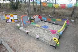 Dia de los Muertos decorations on a grave