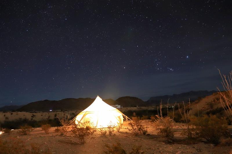 A lit tent under the west Texas dark skies 