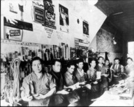 Black and white photo of boot makers in a room 