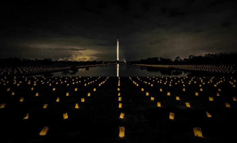 Lit lanterns in front of monument