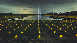Lit lanterns in front of monument