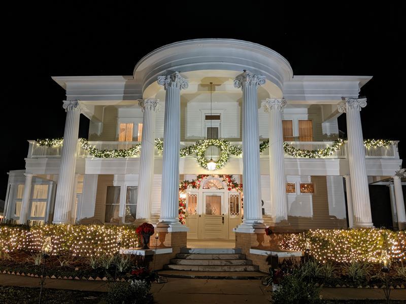 1883 home with Christmas lights 