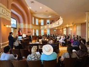 Group of people listening to speaker in court house