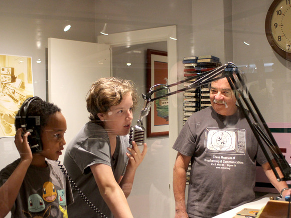 Two children with radio equipment with a teacher 