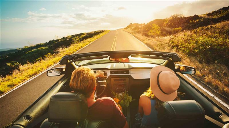 open road two people in a convertible 