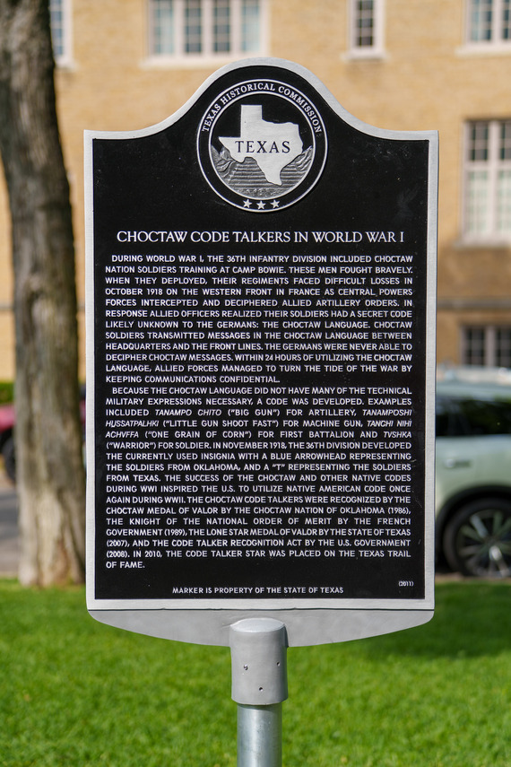 A close-up photo shows a silver-framed black historical marker with white text, titled "Choctaw Code Talkers in World War I."