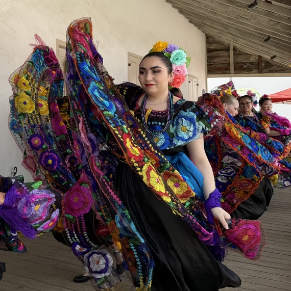 Dancers in Hispanic style dress dance at a festival in San Antonio