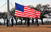 Soldiers raising American flag