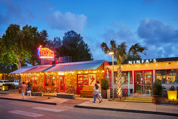 Front of restaurant in evening with neon sign