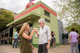 man and woman cheers with coffee cups
