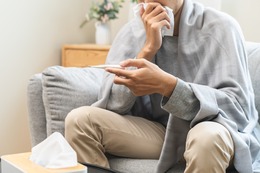 person holding thermometer 