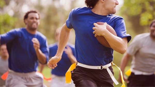Adults playing flag football