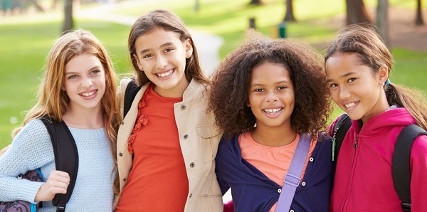 Image of four girls wearing backpacks