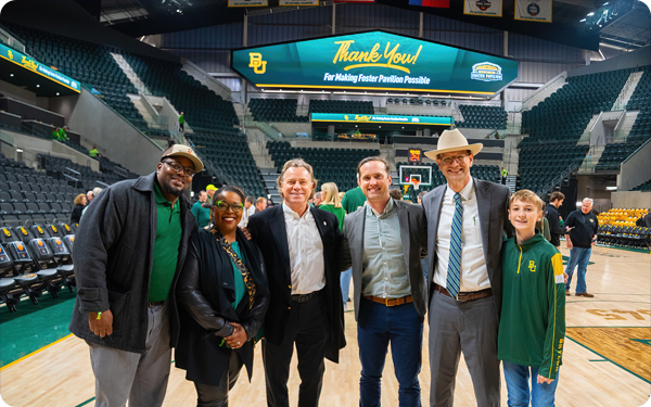 Mayor Dillon Meek and Councilmembers Andrea Barefield and Jim Holmes on the basketball court in the Foster Pavilion arena.