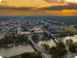 Aerial view of Downtown Waco and the Brazos River during golden hour.