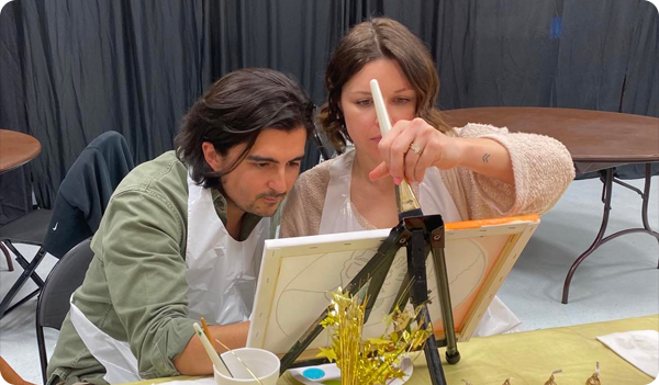 Picture of a couple painting at the 2023 Paint Talk event.